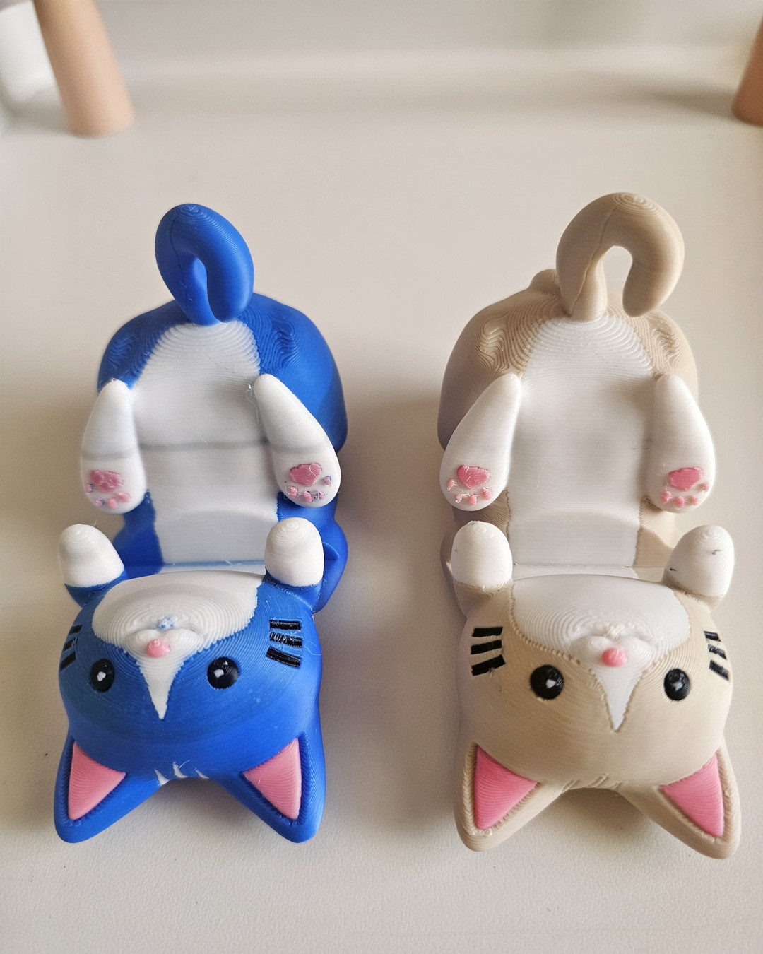 A blue and tan 3D printed cat figure, printed as a single character piece.